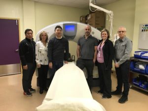 Dr. Dennie and colleagues standing in front of new CT scanner in Iqaluit